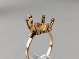 a close up of a gold ring with a crown on top of it