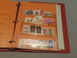 a red binder with stamps on it and a binder with stamps on it