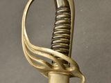 a close up of a sword with a very long handle