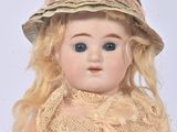 a doll that is wearing a hat and a dress