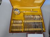 a yellow case with silverware in it on a table