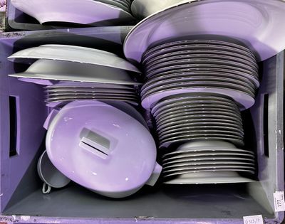 de nombreuses assiettes et casseroles dans une boîte violette