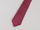 a close up of a red tie on a white surface