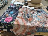 a pile of clothing on a pallet next to a sewing machine