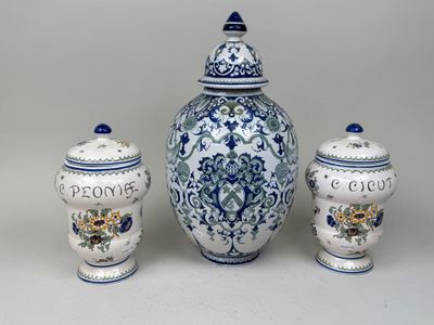 three blue and white vases and a jar with flowers on them