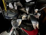 a pile of golf clubs in a bag on the ground