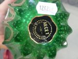 someone is holding a green glass bottle with a label on it