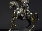 a statue of a man riding a horse on a table