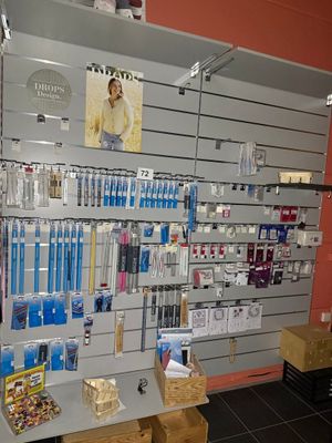 a wall with many different items on it in a store
