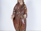 statue of a man holding a cross in his right hand