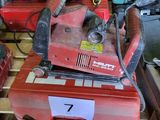 a red machine that is sitting on top of a pallet