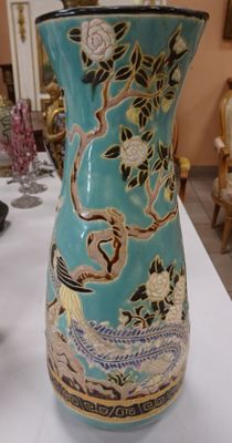 a blue vase sitting on a white table in a room
