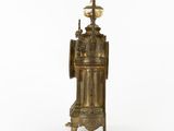 an antique brass clock with a glass globe on top of it