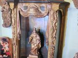 a statue of a woman on a shelf in a room