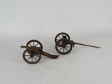 pair of antique cast iron cannon wheels with wooden spokes