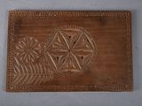 a close up of a brown leather wallet with a design on it