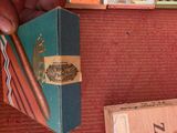 a person holding a cigar in their hand next to a box of cigars
