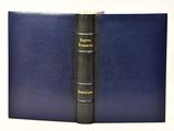 a blue book with a black cover sitting on top of a table