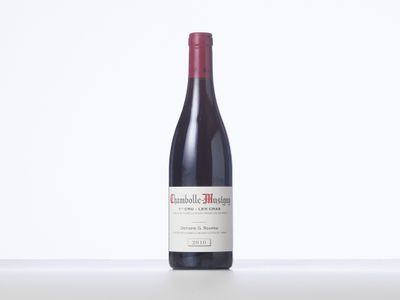 a bottle of red wine sitting on top of a table