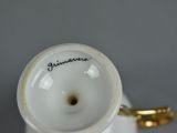 a white cup with a gold handle and a name on it