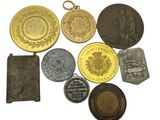 many different types of medals on a white surface