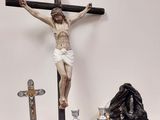 une statue de Jésus sur la croix, à côté de bougies