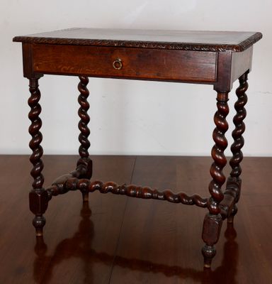 an old wooden table with a drawer on top of it