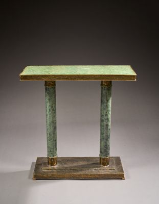 a green marble table with two columns on top of it