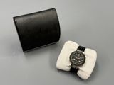 black leather watch case with a watch on it and a watch in it