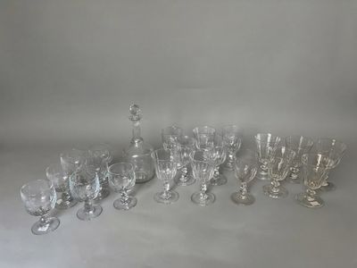 a lot of wine glasses and a decanter on the table