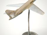a small model of an airplane on a metal stand