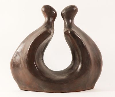 a brown sculpture of two birds on a white background