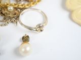 a close up of a ring with pearls and other jewelry