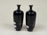 two vases that are sitting on a white surface