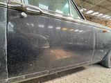 a black car that is parked in a garage