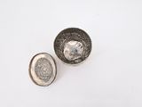 pair of silver plated bowls on a white surface