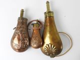 three different types of brass vases on a white surface