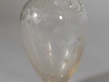 a clear glass vase sitting on a white surface