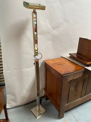 a floor lamp that is next to a wooden table