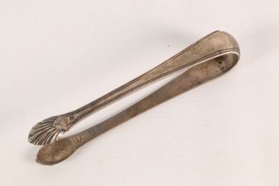 a silver spoon and a spoon rest on a white surface