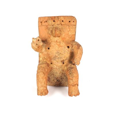 a small statue of a bear sitting on a chair