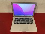 an apple macbook air laptop computer sitting on top of a red table