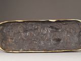 a bronze plaque with a group of people on it