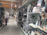 many shelves in the store that have various items on them