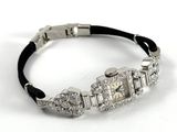 an image of a ladies ' s watch with diamonds on a black leather bracelet