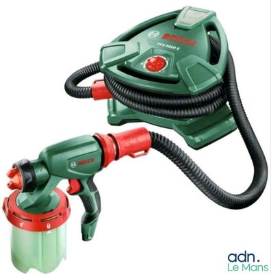 the green and red spray gun is next to a red and black hose