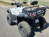 a white four wheeler atv parked on the side of the road