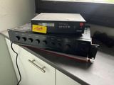a stack of electronics sitting on top of a kitchen counter