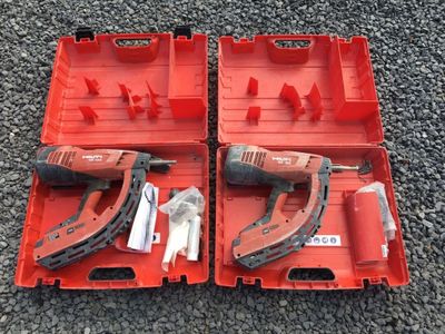 two red tool boxes with tools in them sitting on the ground