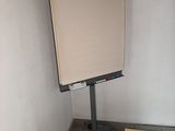 a white board on a stand in the corner of a room